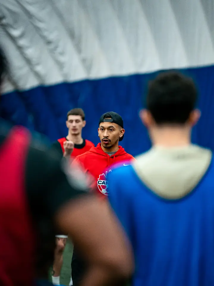 Coach speaking directly to players during a session