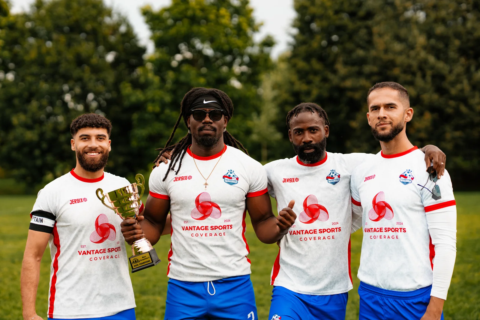 Four Inter Ottawa MC4 players together with the 2026 trophy