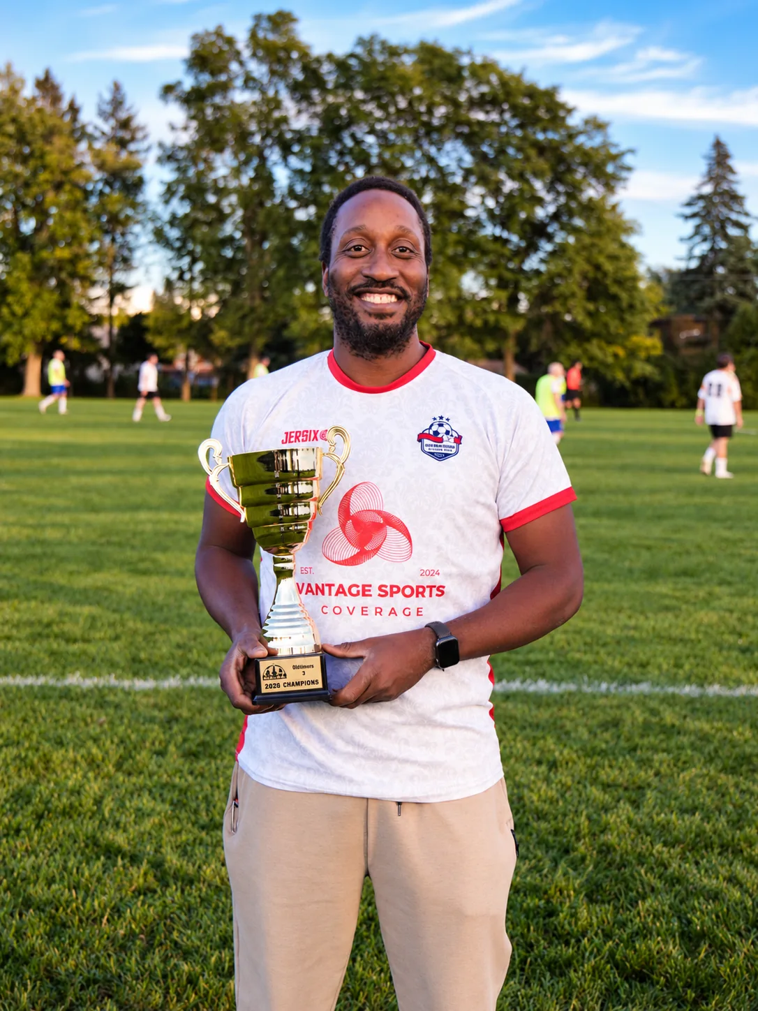 An Inter Ottawa OT3 player holding the 2026 division trophy